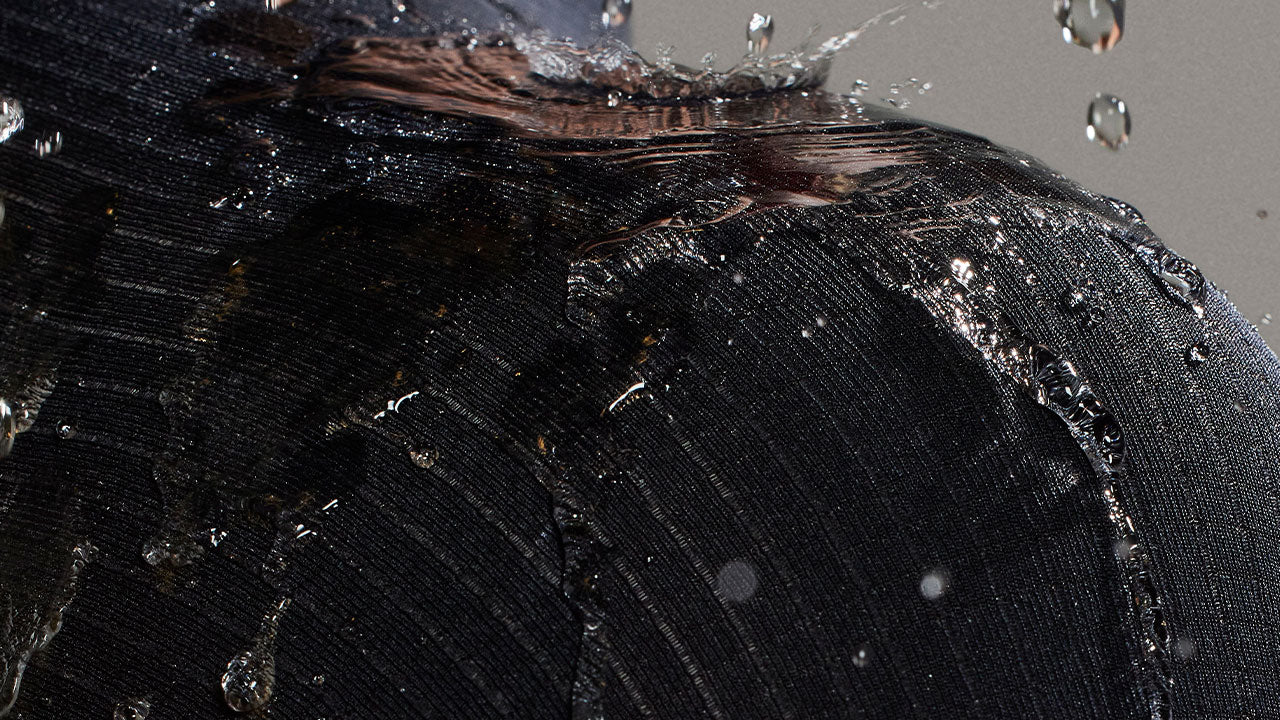 Close up of Xcel wetsuit technology with water dripping off