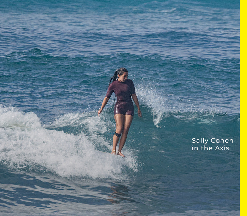 Sally Cohen in the Axis surfing on a wave