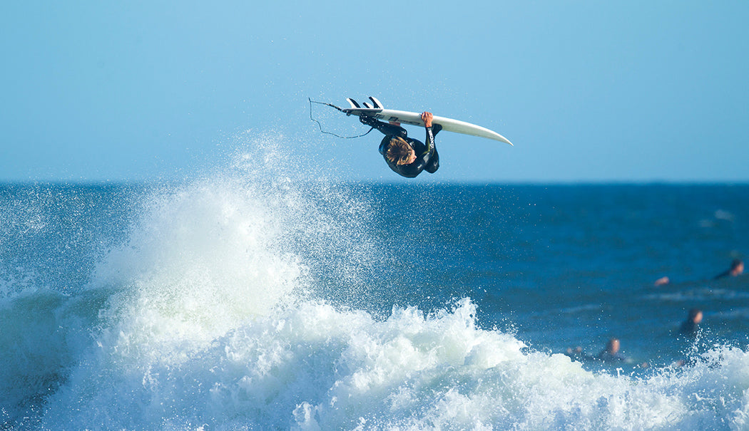 Surfer walking over ice in a fullsuit
